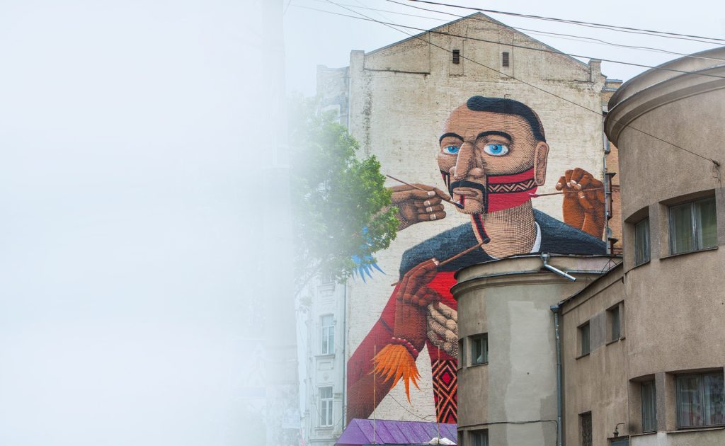 A large street-art mural on a Kyiv building